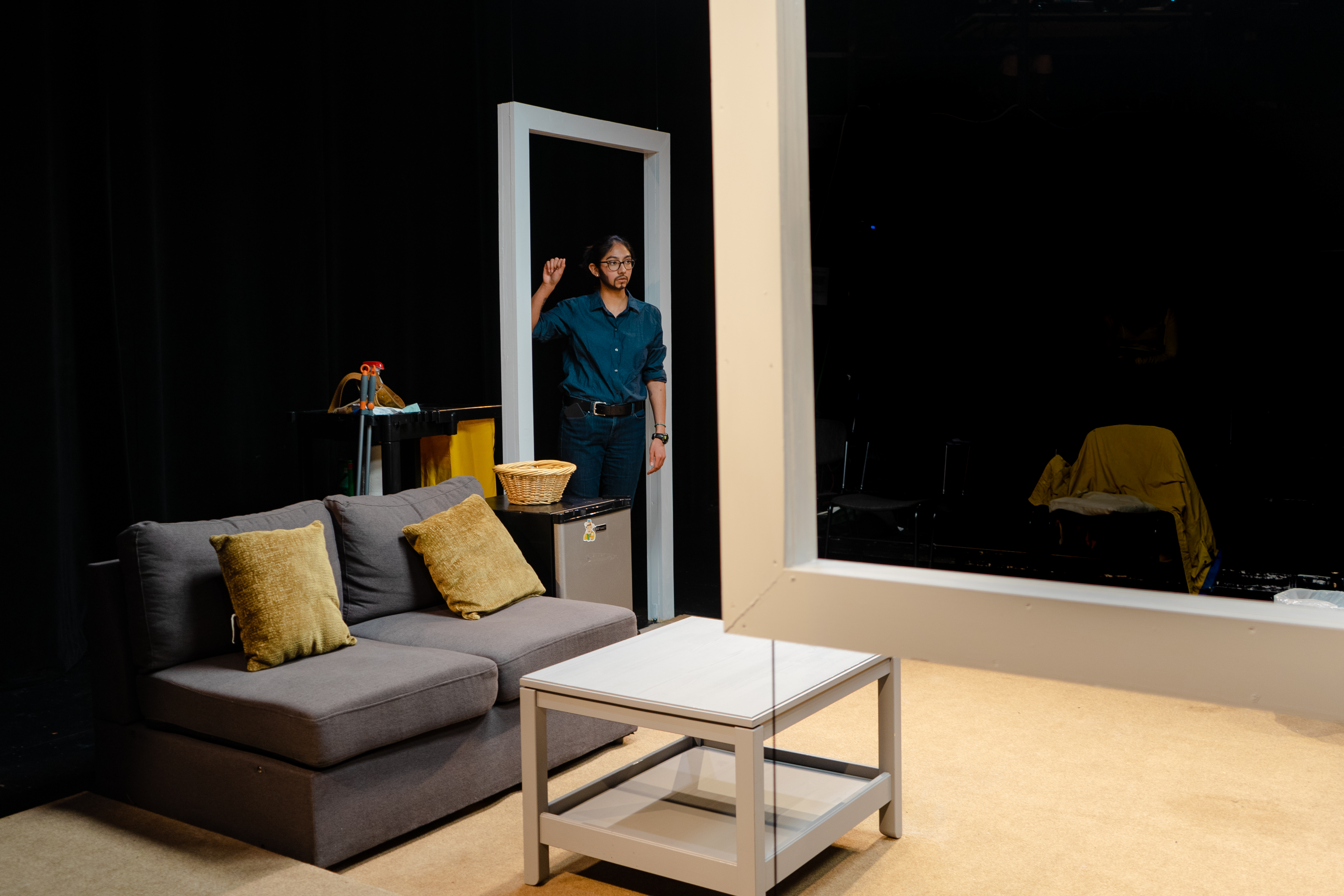 Image of a stage production with props and an actor